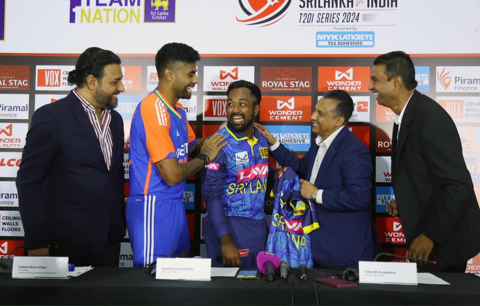 Suryakumar Yadav and Gerald Vanderwall sharing a warm moment with Charith Asalanka at the jersey handover press conference